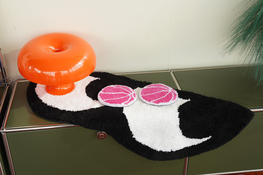 Black and white shaped tufted wall art with pink circles