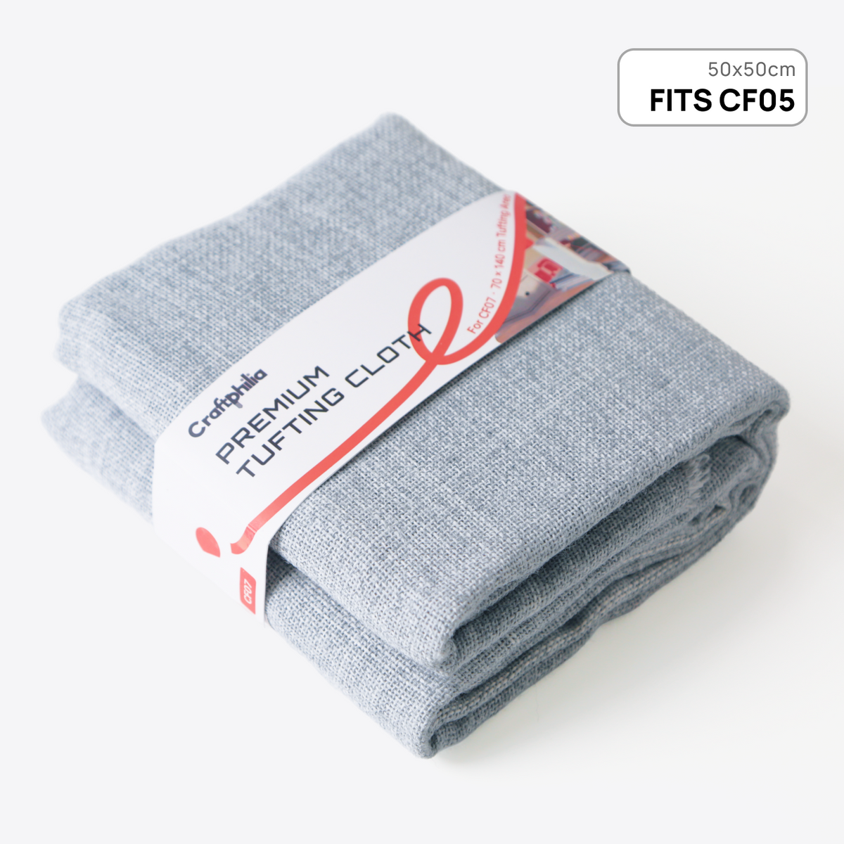 A Craftphilia folded pair of light gray heathered premium tufting cloths wrapped in a white paper band with red and black text, on a clean white background. A small label in the top right corner reads '50x50cm FITS CF05'.