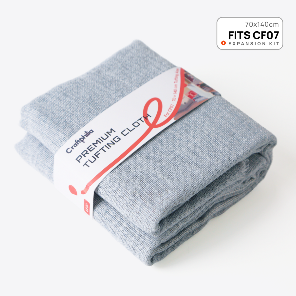 A folded light gray heathered premium tufting cloth by Craftphilia, wrapped in a white paper band with red accents. The band reads 'Craftphilia PREMIUM TUFTING CLOTH' and includes a 'FITS CF07' label.